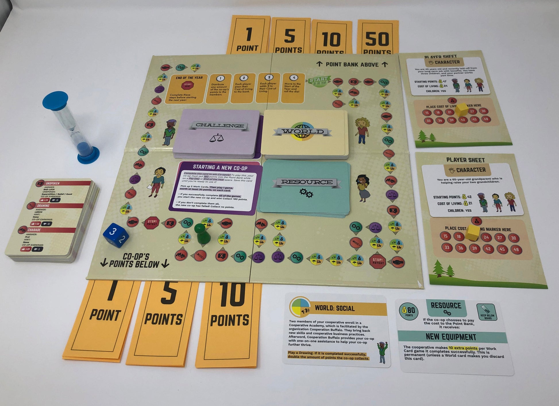 Board game components including cards and a board on a white surface